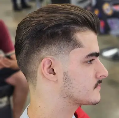 Side profile of a swept-back haircut with softly blended fade from Vincenzo’s haircut portfolio