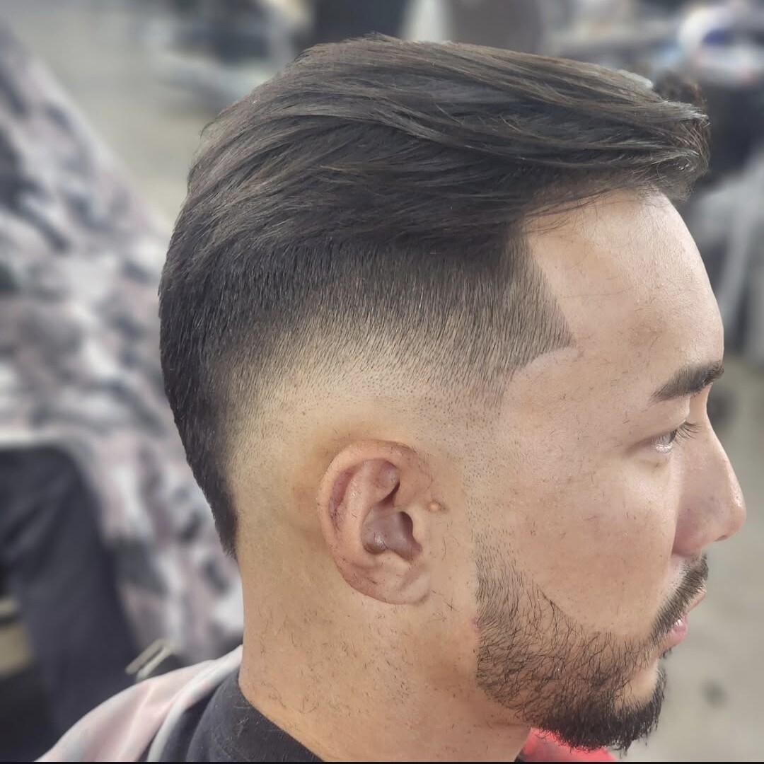 Low taper fade with beard blend at Prestige Barbers