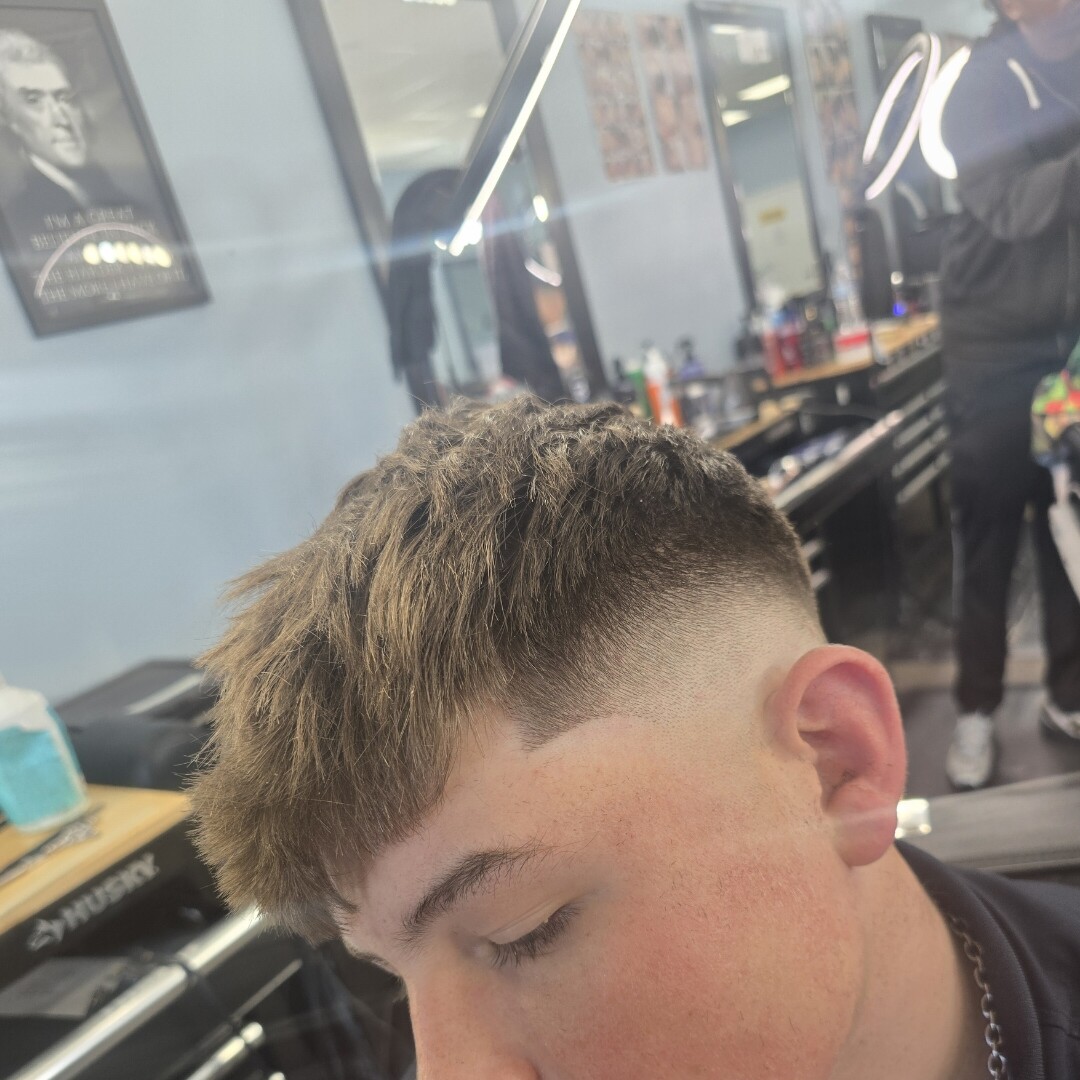 Textured crop with mid fade at Prestige Barbers